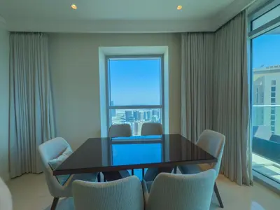 a dining room with a table and chairs and a large window at The Address Fountain Views Residence High Floor with Burj Khalifa view and access to Dubai mall in Dubai