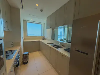 a kitchen with white cabinets and a sink and a window at The Address Fountain Views Residence High Floor with Burj Khalifa view and access to Dubai mall in Dubai