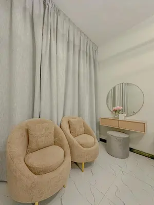 a living room with two chairs and a mirror at Studio Apartment in Rukan Wadi Al Safa by the S Holiday Homes in Dubai