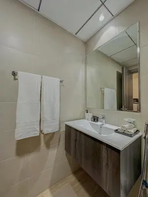a bathroom with a sink and a mirror at Studio Apartment in Rukan Wadi Al Safa by the S Holiday Homes in Dubai