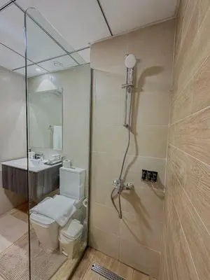 a bathroom with a shower and a toilet and a sink at Studio Apartment in Rukan Wadi Al Safa by the S Holiday Homes in Dubai