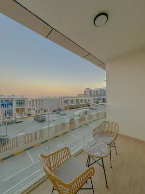 two chairs and a table on a balcony with a view at Studio Apartment in Rukan Wadi Al Safa by the S Holiday Homes in Dubai