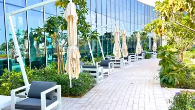 a row of chairs and umbrellas in a building at Luxe Dubai Marina Apartment 5242 Building 2bhk in Dubai