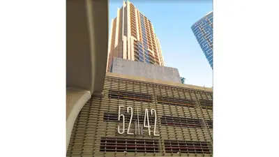 a view of a building with the om sign on it at Luxe Dubai Marina Apartment 5242 Building 2bhk in Dubai