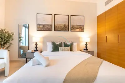 a bedroom with a large white bed and two lamps at City View Studio, Minutes Away from Dubai Opera, Burj Khalifa and Dubai Mall, Claren Tower 2, Downtown Dubai by Deluxe Holiday Homes in Dubai
