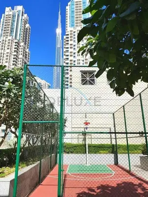 a basketball court in a city with tall buildings at City View Studio, Minutes Away from Dubai Opera, Burj Khalifa and Dubai Mall, Claren Tower 2, Downtown Dubai by Deluxe Holiday Homes in Dubai