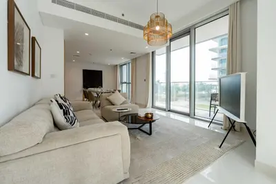 a living room with a couch and a flat screen tv at TRPS - Beach Isle Tower 1, Dubai Harbour - 1BR Premium Beachfront - Private Beach Access in Dubai