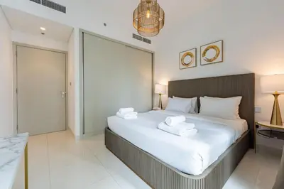 a bedroom with a large bed with towels on it at TRPS - Beach Isle Tower 1, Dubai Harbour - 1BR Premium Beachfront - Private Beach Access in Dubai