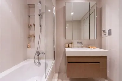a bathroom with a shower and a sink and a mirror at TRPS - Beach Isle Tower 1, Dubai Harbour - 1BR Premium Beachfront - Private Beach Access in Dubai