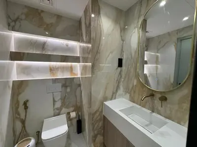 a bathroom with a sink and a mirror and a toilet at A unique luxury touch in JLT in Dubai