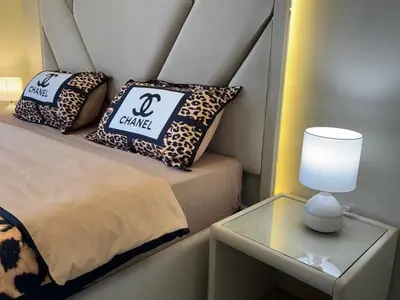 a room with a bed and a table with a lamp at A unique luxury touch in JLT in Dubai