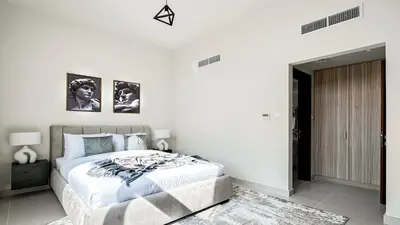 a white bedroom with a large bed in it at Trophy-Lux Villa w Big Garden & BBQ Grill in Dubai