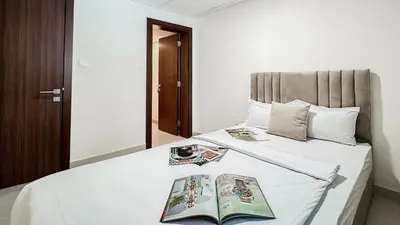 a bedroom with a bed with two books on it at Trophy-Lux Villa w Big Garden & BBQ Grill in Dubai
