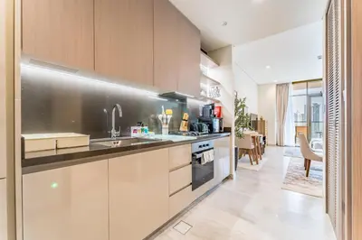 a kitchen with a sink and a counter top at Luxury Studio Steps from Dubai Canal and Minutes to Burj Khalifa, Peninsula Five - 3, Business Bay By Deluxe Holiday Homes in Dubai