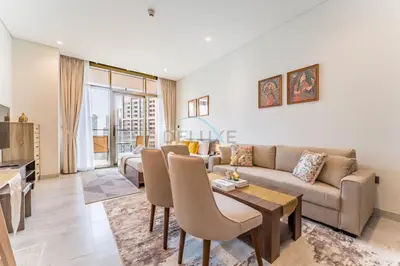 a living room with a couch and a table at Luxury Studio Steps from Dubai Canal and Minutes to Burj Khalifa, Peninsula Five - 3, Business Bay By Deluxe Holiday Homes in Dubai