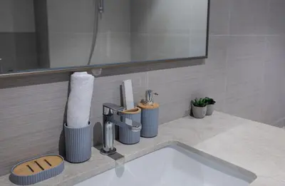 a bathroom counter with a sink and a mirror at Luxury Stay Just Steps from Dubai Mall 2BR Grande in Dubai