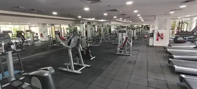 a gym with a lot of treadms and machines at Chic 1BR with the City Views in Dubai