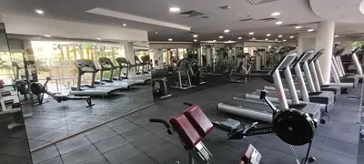 a gym with rows of treadmills and machines at Chic 1BR with the City Views in Dubai