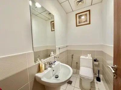 a bathroom with a sink and a toilet and a mirror at Chic 1BR with the City Views in Dubai