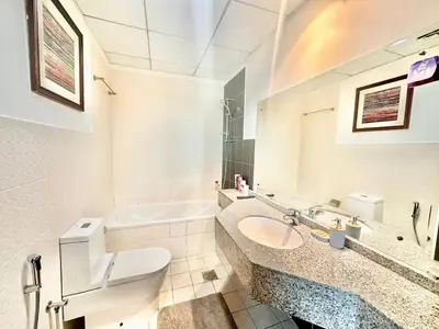 a bathroom with a toilet and a sink and a tub at Chic 1BR with the City Views in Dubai