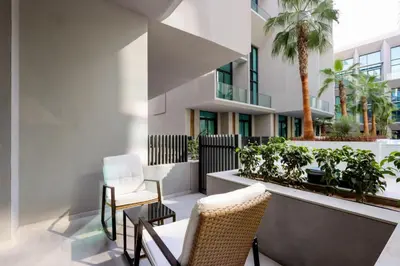 an apartment patio with chairs and plants at Livbnb - Stylish Studio in JVC, Near Parks and Shops in Dubai