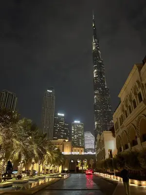 a view of a city at night with a tall building at Cozy 1BR Apart Downtown Burj Khalifa and Dubai Mall in Dubai