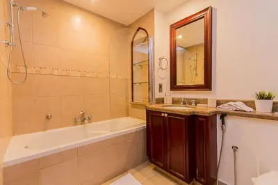 a bathroom with a tub and a sink and a shower at Cozy 1BR Apart Downtown Burj Khalifa and Dubai Mall in Dubai