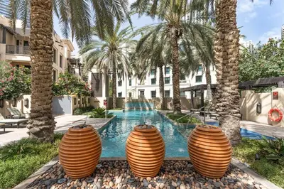 a group of three large vases next to a swimming pool at Cozy 1BR Apart Downtown Burj Khalifa and Dubai Mall in Dubai
