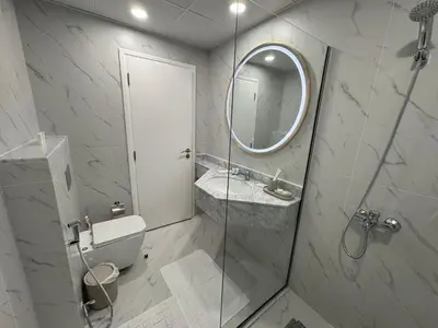 a bathroom with a toilet and a sink and a mirror at Icon tower 1 , JLT 1BHK apartment in Dubai