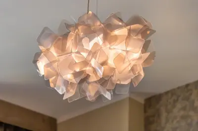 a large light fixture hanging from a ceiling at 2BR by Sea, 15min to Dubai Mall in Dubai