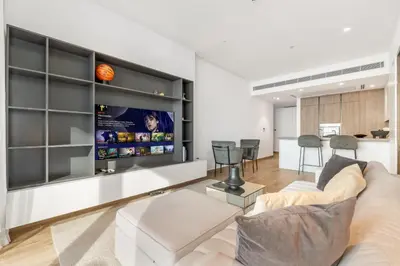 a living room with a couch and a tv at 1BR Jumeirah Living - Marina View - 5 STARS Facilities in Dubai