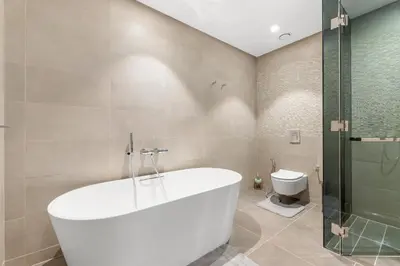 a bathroom with a bath tub and a toilet at 1BR Jumeirah Living - Marina View - 5 STARS Facilities in Dubai