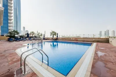 a large swimming pool on the roof of a building at Stylish 2BR in Elite Tower with Bluewaters View and JBR in Dubai