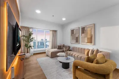 a living room with a couch and a tv at Stylish 2BR in Elite Tower with Bluewaters View and JBR in Dubai
