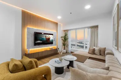 a living room with a couch and a tv at Stylish 2BR in Elite Tower with Bluewaters View and JBR in Dubai