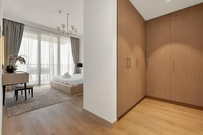 a bedroom with a bed and a desk and a table at Luxurious, Creek & Marina View in Dubai