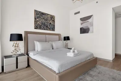 a bedroom with a white bed with a teddy bear on it at Luxurious, Creek & Marina View in Dubai