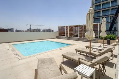a swimming pool on the roof of a building at Stylish 1-Bedroom in Binghatti House JVC in Dubai