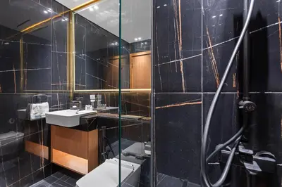 a bathroom with a shower and a toilet and a sink at Stylish 1-Bedroom in Binghatti House JVC in Dubai