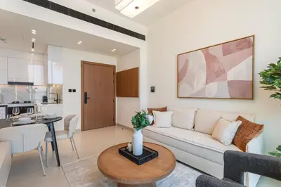 a living room with a couch and a table at Stylish 1-Bedroom in Binghatti House JVC in Dubai