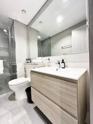 a bathroom with a sink and a toilet at Canal Luxe Burj 1BR Sleeps 4 with Pool and Gym in Dubai