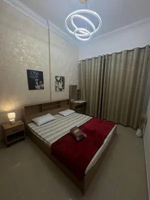 a bedroom with a large bed and a chandelier at Dream home in Dubai