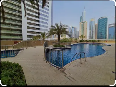 a swimming pool in a city with tall buildings at Dream home in Dubai