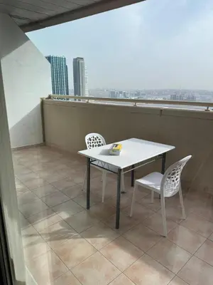 a white table and two chairs on a balcony at Dream home in Dubai