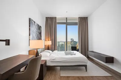 a hotel room with a bed and a desk and a window at The Marina Observatory-Jumeirah Living Marina Gate in Dubai