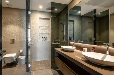 a bathroom with two sinks and a shower at The Marina Observatory-Jumeirah Living Marina Gate in Dubai