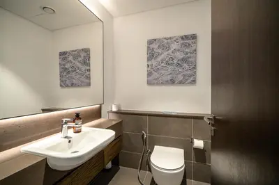 a bathroom with a sink and a toilet at The Marina Observatory-Jumeirah Living Marina Gate in Dubai