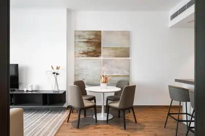 a dining room with a white table and chairs at The Marina Observatory-Jumeirah Living Marina Gate in Dubai