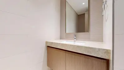a bathroom with a sink and a mirror at Grand Bleu 2 - Sophisticated Two Bed with Sea View in Dubai