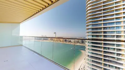 a balcony with a view of a building at Grand Bleu 2 - Sophisticated Two Bed with Sea View in Dubai
